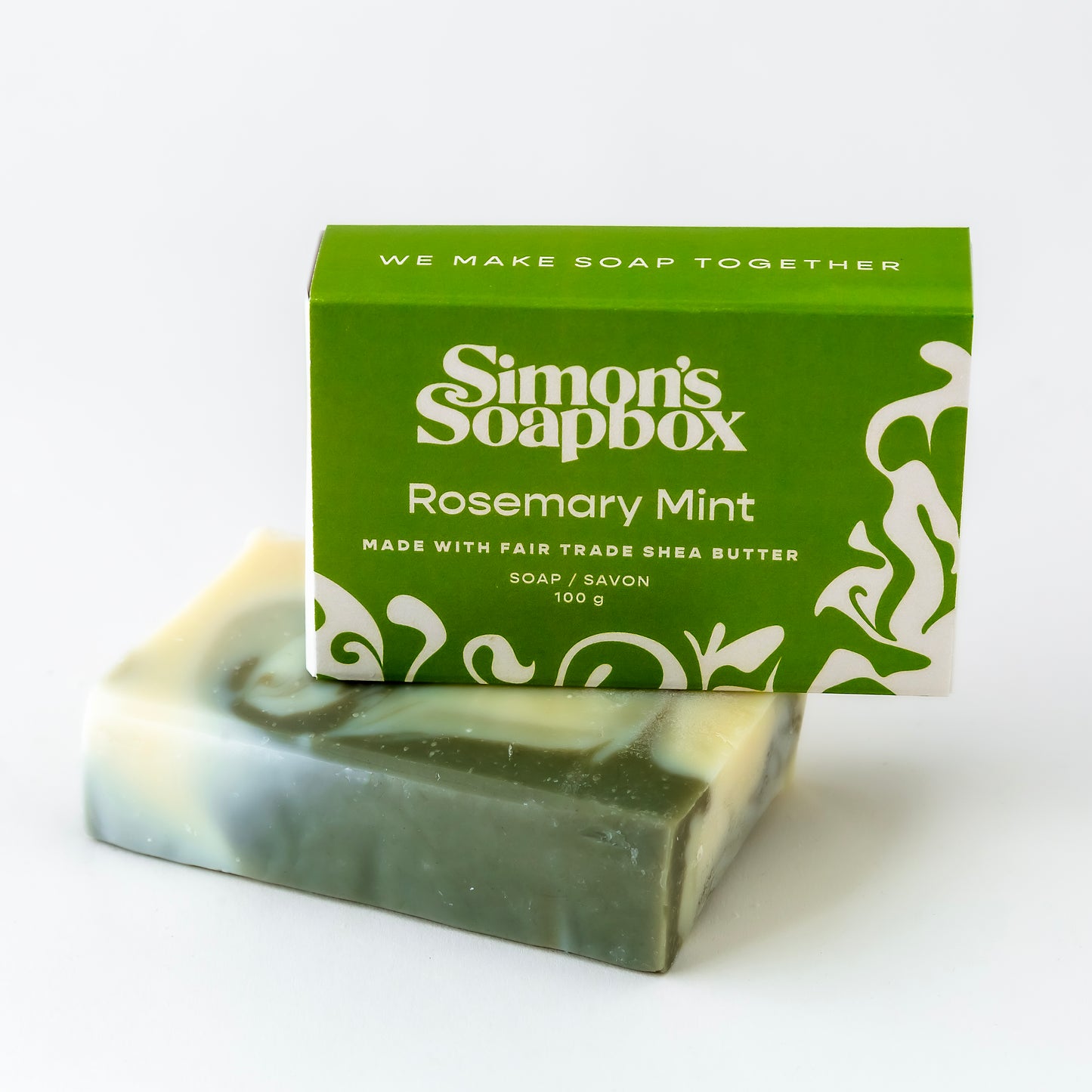 packaged bar of soap on top of unwrapped soap bar