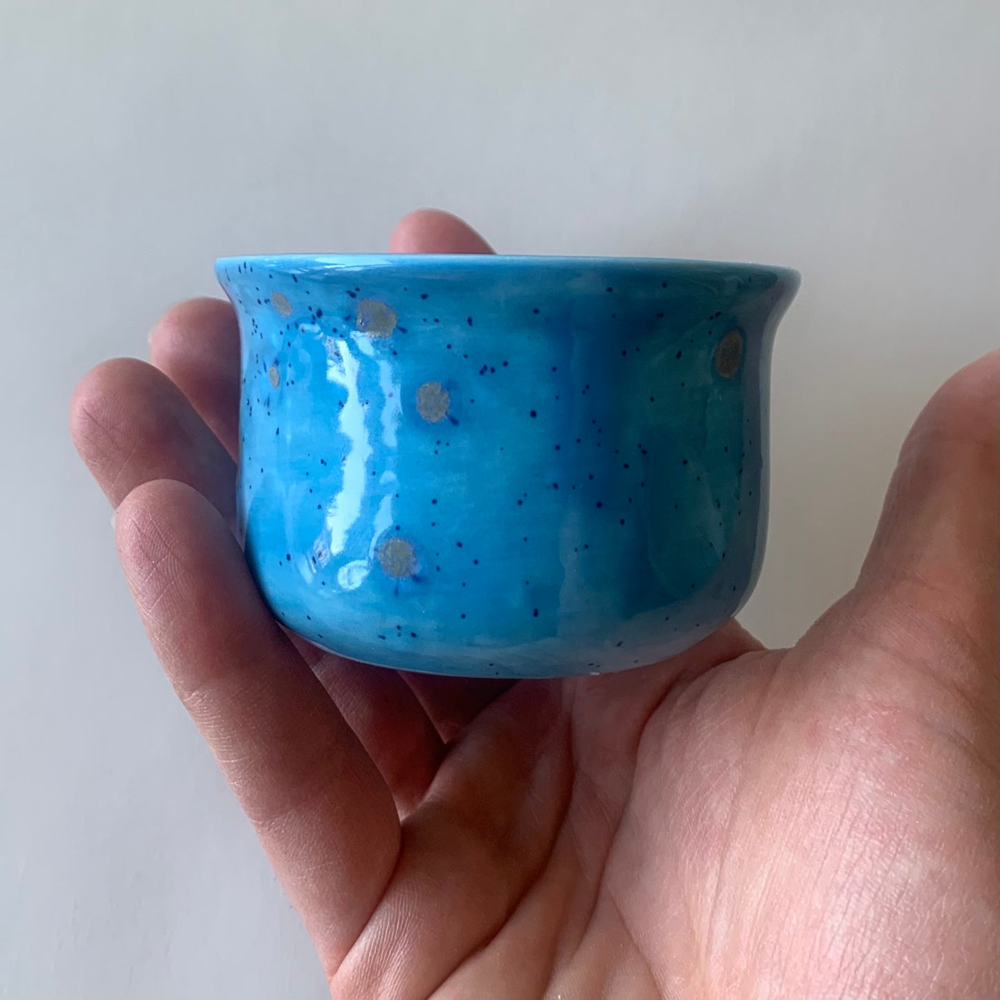 blue ramekin side view held in hand