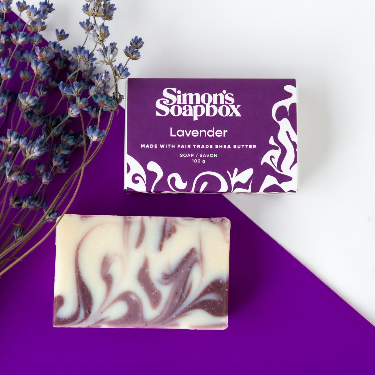 unpackaged and packaged bars of soap beside lavender flowers