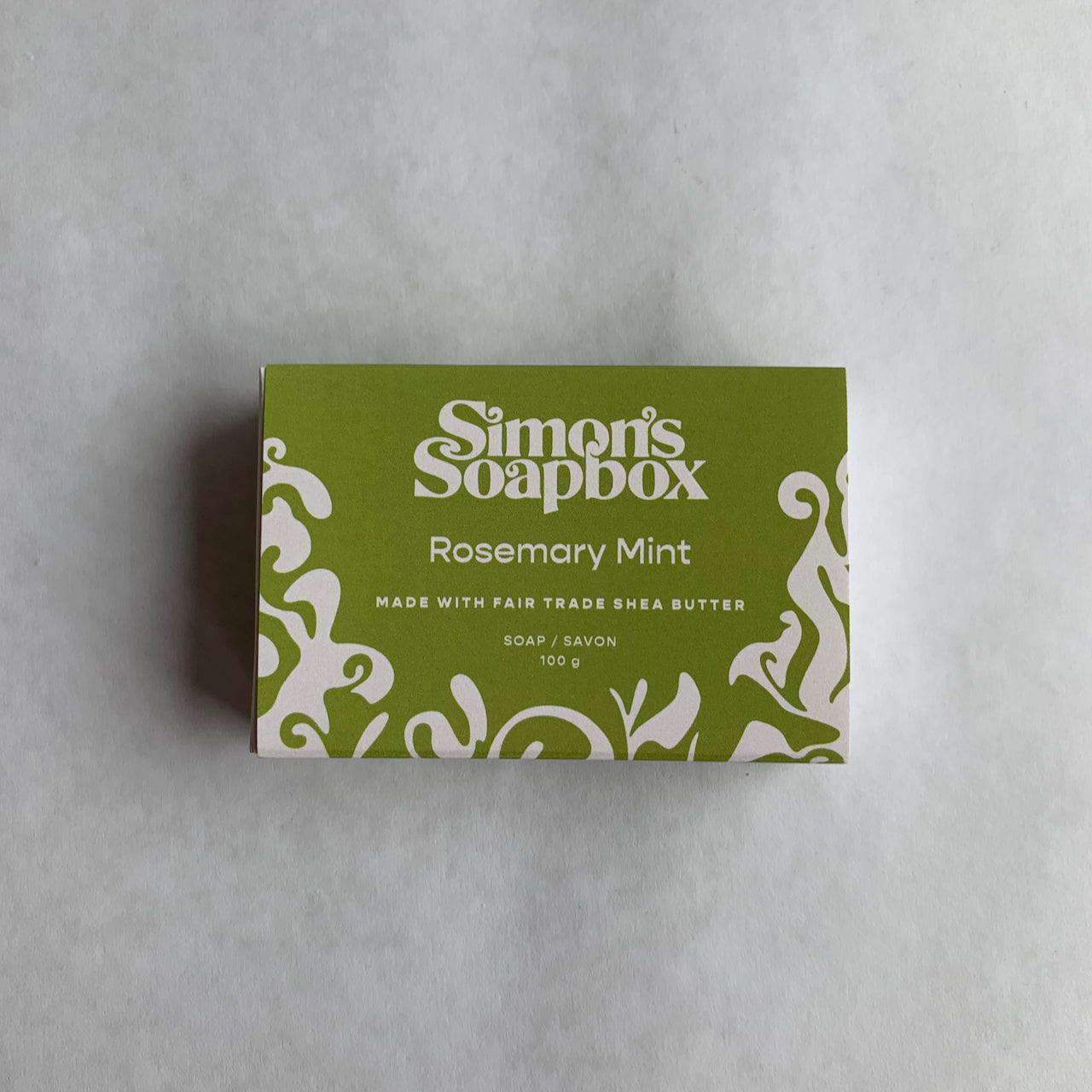 green package that reads Simon's Soapbox Rosemary Mint made with fair trade shea butter soap/savon 100 g