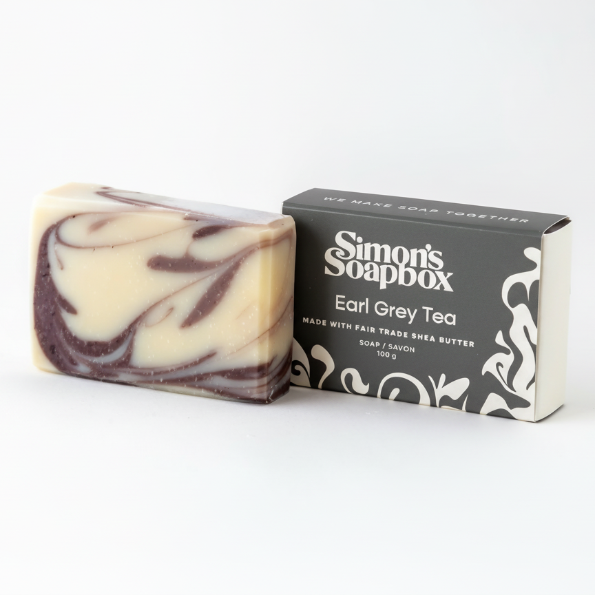Swirled soap bar with packaging labeled 'Simon's Soapbox Earl Grey Tea' on a white background