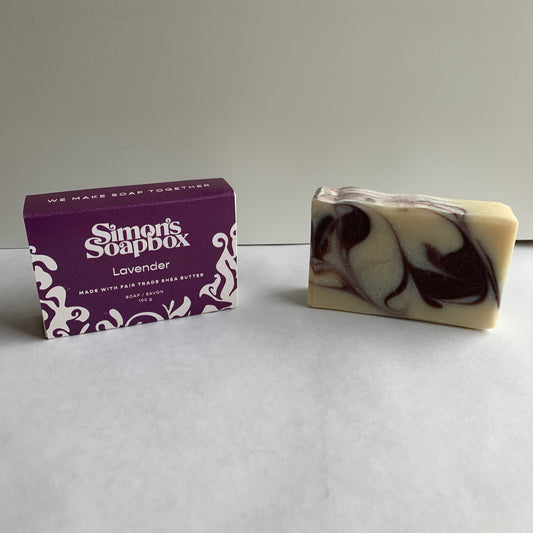 two bars of soap one with a purple swirl, one in a package