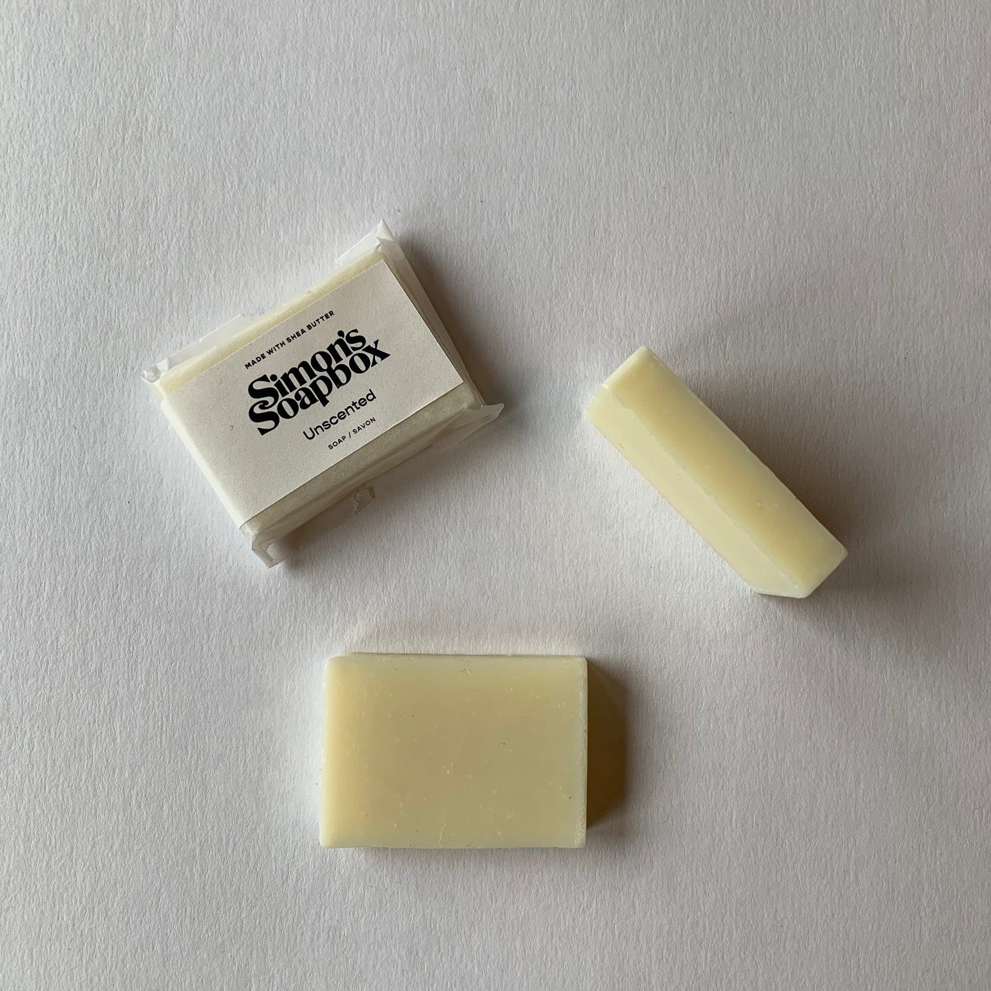 three views of soap, wrapped with sticker label, top view, side view